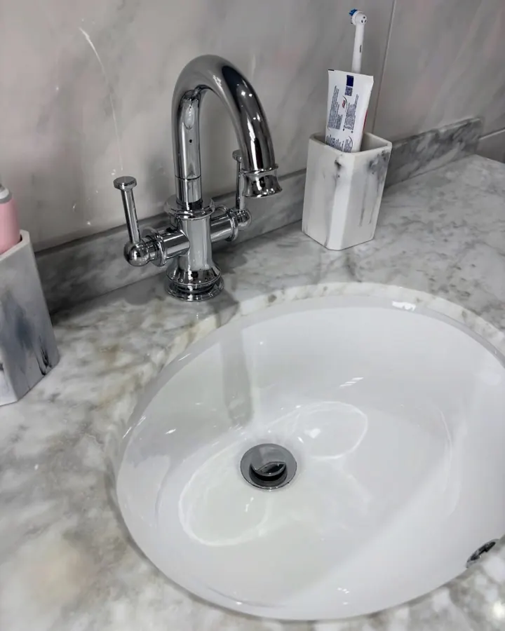 A marble vanity top and basin left spotless