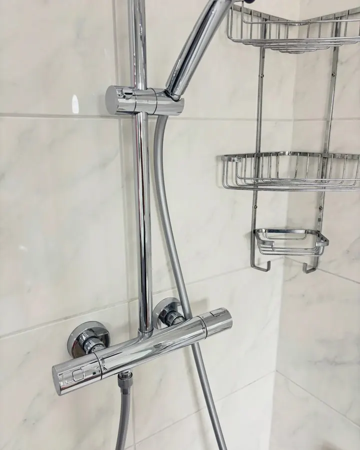 A chrome shower valve and riser rail free of limescale