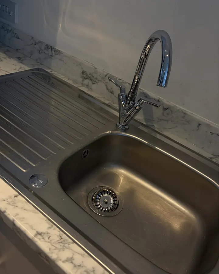 A stainless steel sink polished clean