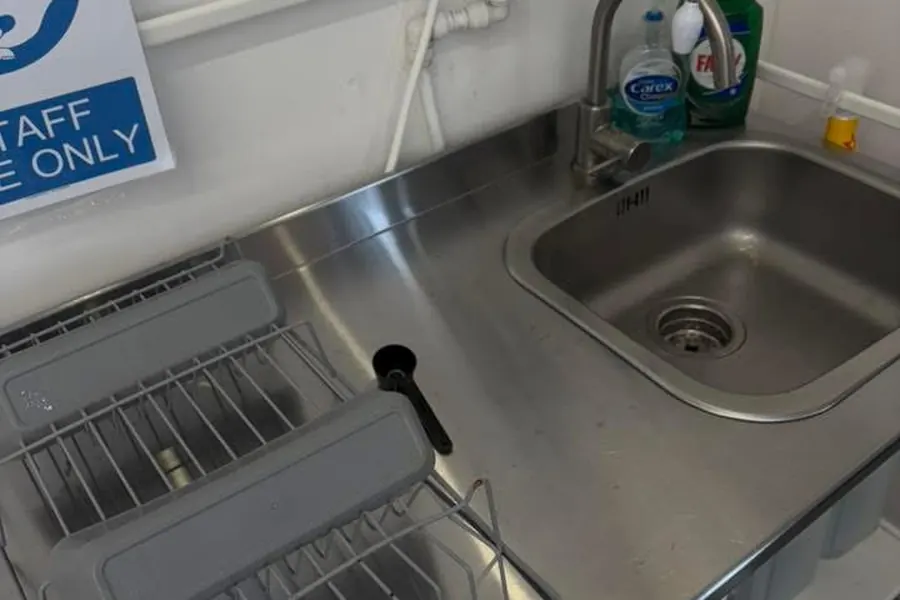 The same staff kitchenette after cleaning, worktop clear and wiped down