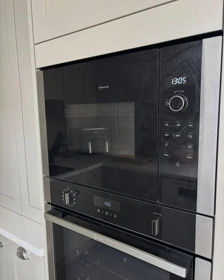 Built-in oven and microwave with smeared glass before cleaning