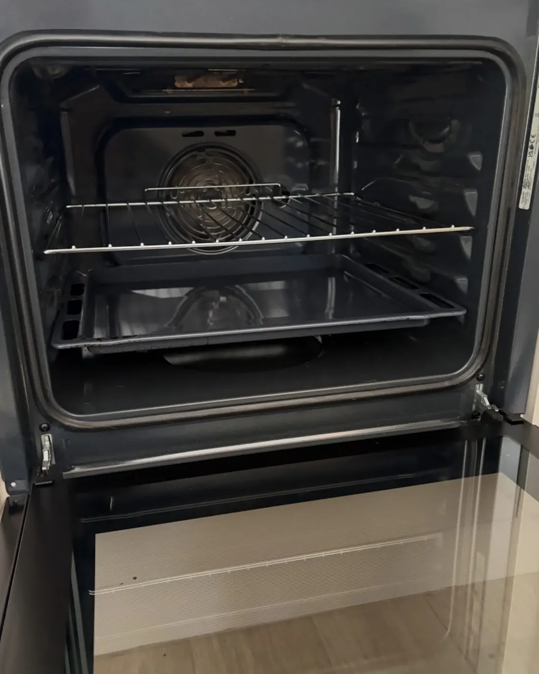 The same oven after cleaning, with a clear glass door and a clean cavity